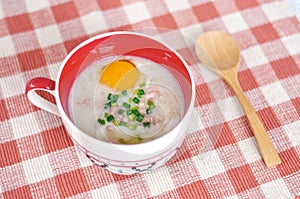 Rice porridge with egg in cute bowl photo