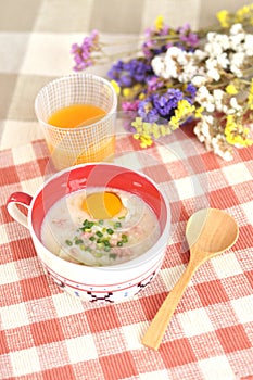 Rice porridge with egg in cute bowl