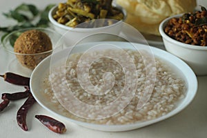 Rice porridge or Kanji along with spicy coconut red chilly chutney, stir fried boiled red cowpea beans and stir fried raw banana