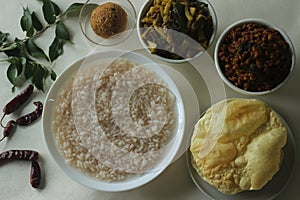 Rice porridge or Kanji along with spicy coconut red chilly chutney, stir fried boiled red cowpea beans and stir fried raw banana