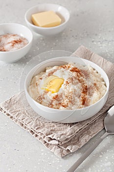 Rice pudding with butter cinnamon. french riz au lait, norwegian risgrot, traditional breakfast dessert