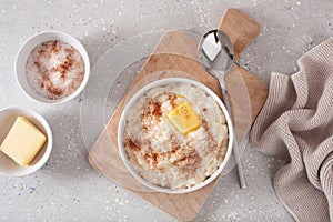 Rice pudding with butter cinnamon. french riz au lait, norwegian risgrot, traditional breakfast dessert photo