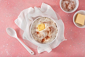 Rice pudding with butter cinnamon. french riz au lait, norwegian risgrot, traditional breakfast dessert photo