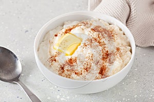 rice pudding with butter cinnamon. french riz au lait, norwegian risgrot, traditional breakfast dessert photo