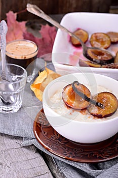 Rice pudding with caramel vanilla plums photo