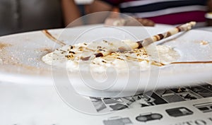 Rice pudding with chocolate chips and burnt sugar on white plate photo