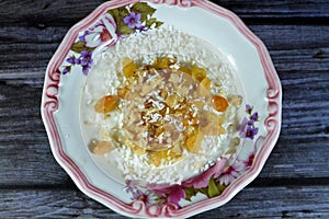 Rice pudding, a dish made from rice, corn flour, sugar mixed with water or milk and other ingredients, nuts, cinnamon, vanilla and