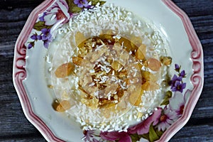 Rice pudding, a dish made from rice, corn flour, sugar mixed with water or milk and other ingredients, nuts, cinnamon, vanilla and