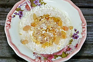 Rice pudding, a dish made from rice, corn flour, sugar mixed with water or milk and other ingredients, nuts, cinnamon, vanilla and