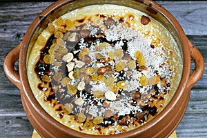 Rice pudding pottery casserole over baked burnt in the oven, rice, corn flour, sugar, water or milk and other ingredients such as