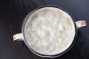 Rice pudding in white plate on dark background