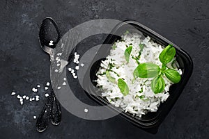 Rice ready with ginger and basil for a healthy diet. View from above on a dark background. Vegetarian diet dish