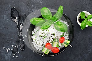 Rice ready with ginger and basil for a healthy diet. View from above on a dark background. Vegetarian diet dish