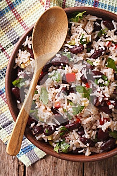 Rice with red beans in a bowl close-up on the table. vertical to photo