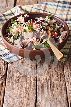 Rice with red beans and other vegetables in a bowl. vertical photo