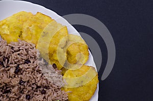 Rice with red beans and tostones photo