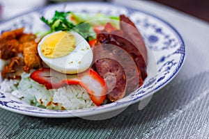 Rice with Red Roast Pork Served Boiled Egg and topped with Sweet Sauce.