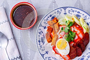 Rice with Red Roast Pork Served Boiled Egg and topped with Sweet Sauce.