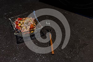 Rice salad in a bowl and a fork, rustic style and selective focus