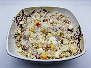 Rice salad on dish, white background
