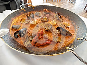 Rice with seafood in a large frying pan