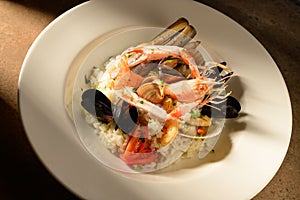 Rice with seafood on a plate in restauant ready to be served