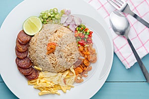 Rice Seasoned with Shrimp Paste, Thai food on white dish over wooden table.