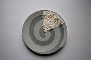 Rice sector on grey concrete plate from above