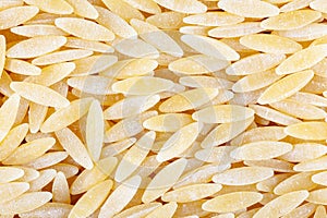 Rice-shaped pasta texture. View from above. Close-up