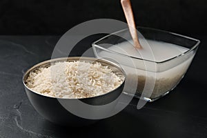 Rice soaked in water on black table