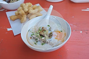 Rice soup or Congee minced pork and entrails with egg photo