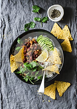 Rice with spicy beans beef minced with corn chips on a gray background, top view. Mexican style food