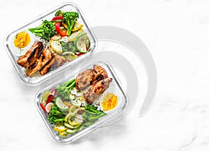 Rice, stewed vegetables, egg, teriyaki chicken - healthy balanced lunch box on a light background, top view. Home food for office