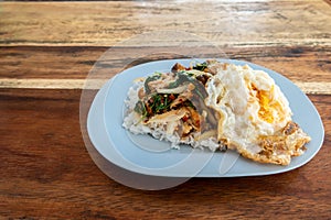 Rice and stir-fried crispy pork and basil with Fried egg background