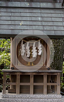 rice straw and paper Shimenawa in front of small shrine