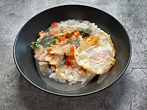 Rice topped with crispy pork belly with Thai basil