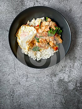 Rice topped with crispy pork belly with Thai basil