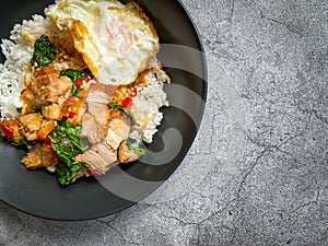 Rice topped with crispy pork belly with Thai basil