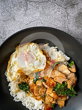 Rice topped with crispy pork belly with Thai basil