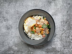 Rice topped with crispy pork belly with Thai basil