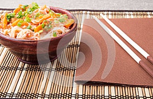 Rice vermicelli hu-teu in a small brown wooden bowl