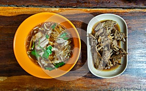 Rice vermicelli with stewed duck meat Duck noodle and Boiled duck wing stewing in soy sauce on wooden table