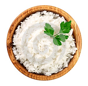 Rice in a wooden bowl isolated on white background. Top view. Flat lay