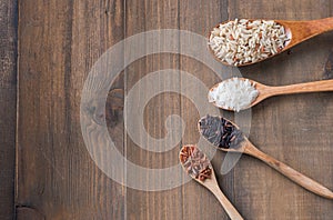 Riceberry brown rice Jasmine rice on wood spoon