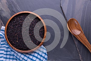 Riceberry rice in wooden blow and background