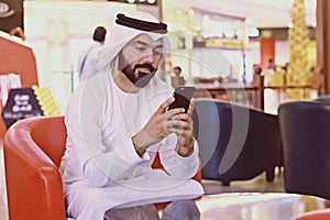 Rich Arab Business Man Using Internet Mobile Phone In Cafe Shop