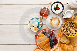 Rich breakfast menu on wooden table, copy space