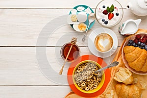 Rich breakfast menu on wooden table, copy space