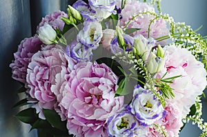 Rich bunch of pink peonies peony and lilac eustoma roses flowers. Rustic style, still life. Fresh spring bouquet, pastel