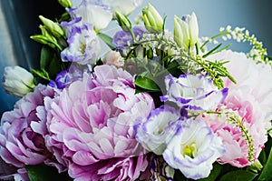 Rich bunch of pink peonies peony and lilac eustoma roses flowers. Rustic style, still life. Fresh spring bouquet, pastel colors. B